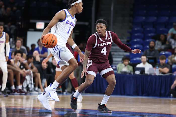 Texas A&M Aggies point guard Wade Taylor IV guards DePaul Blue Demons forward Javan Johnson.
